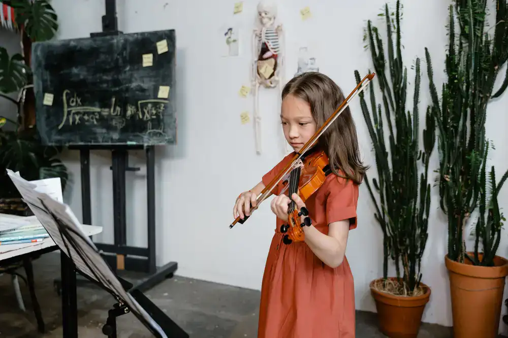 A student happily practicing their instrument at the school