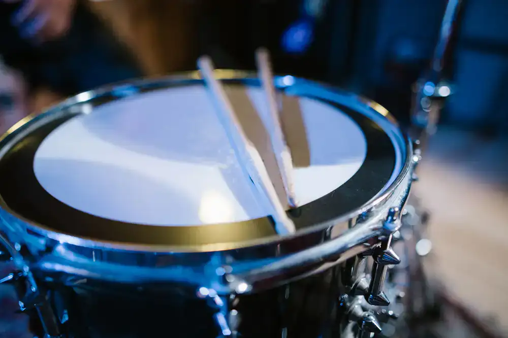 Drumsticks resting on a snare drum