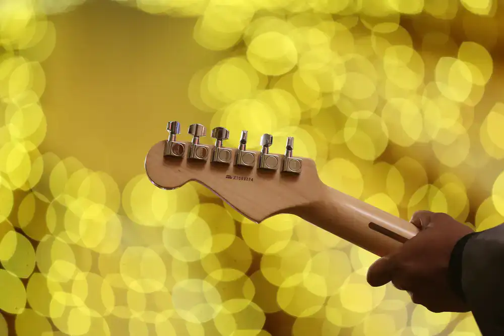 Student holding an electric guitar