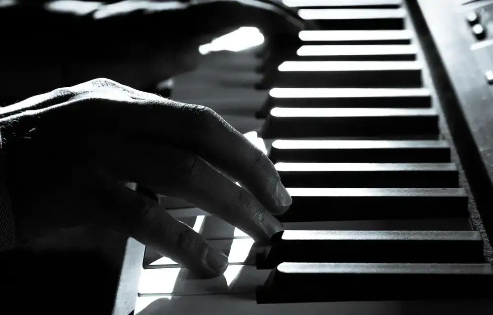 Close up of hands playing a piano keyboard