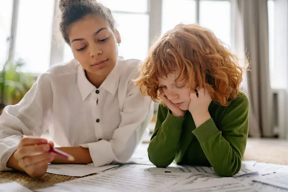 A music teacher guiding a student reading sheet music