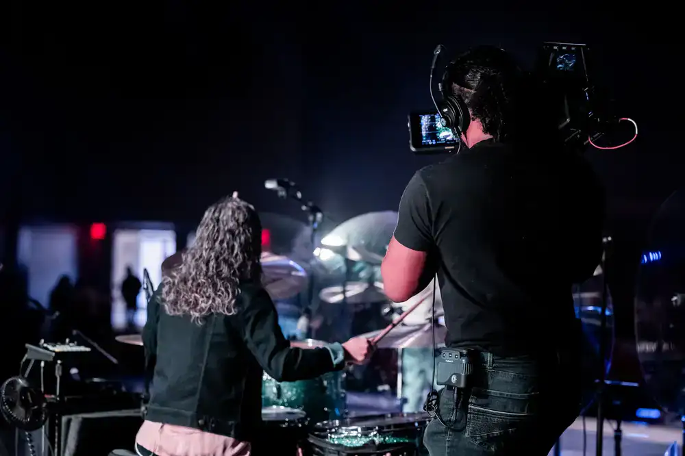 Drum instructor behind a drum kit
