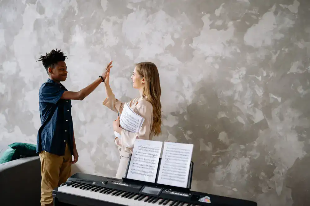 Teacher and student smiling during a music lesson
